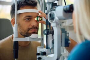 Young man having an eye exam for corneal evaluation.