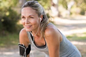 Jogging woman in her 40s enjoys her vision without the need for glasses.